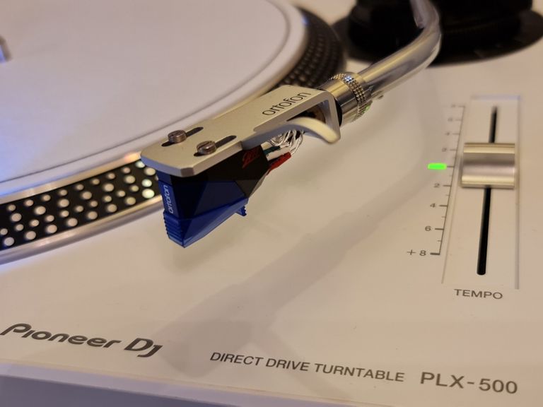 Silver Ortofon SH-4 tonearm headshell and a Ortofon 2M blue, moving magnet cartridge/stylus.